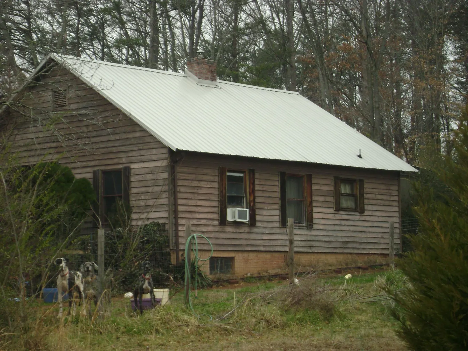 White metal roof on an old wood sided farmhouse, from a Asphalt Shingle Roof Repair job in Salemburg